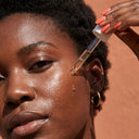 girl placing ampule on her face