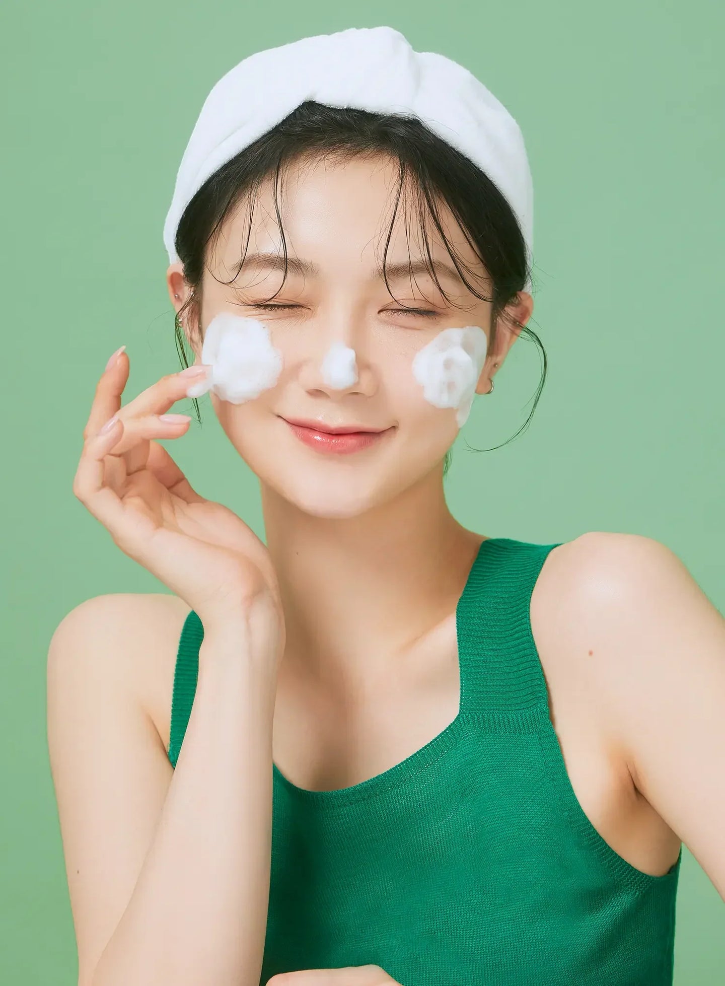 Squeezing relaxing cica cleansing foam onto hand for K-beauty centella daily cleanse