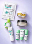 A flat-lay arrangement of skincare products on a light lavender background, including an APLB glutathione niacinamide sheet mask, a jar of lip glutation, a dropper bottle of serum, a cream tube, a black scrub jar, and two green-tinted Purit skin care bottles.