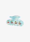 Azure Berry Blue Hair Pin IL529 blue marble resin claw clip three-quarter front view showing cherry rhinestone motifs and crystal rhinestone trim on top edge