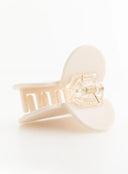 Grace Heart Hair Clip IL503 Cream bottom angle close-up revealing inner comb teeth and clear gold-tone spring hinge detail